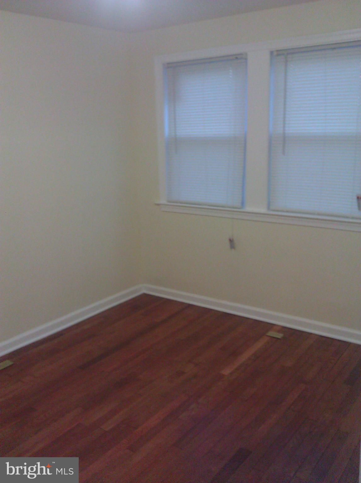 148 West Edgevale Road Baltimore, MD 21225 - Photo 9 of 12 a view of a small space with wooden floor and a window