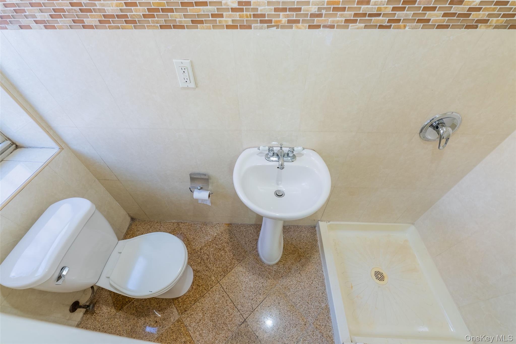 102-23 43rd Avenue, Unit 1B Queens, NY 11368 - Photo 14 of 18 a bathroom with a sink and toilet