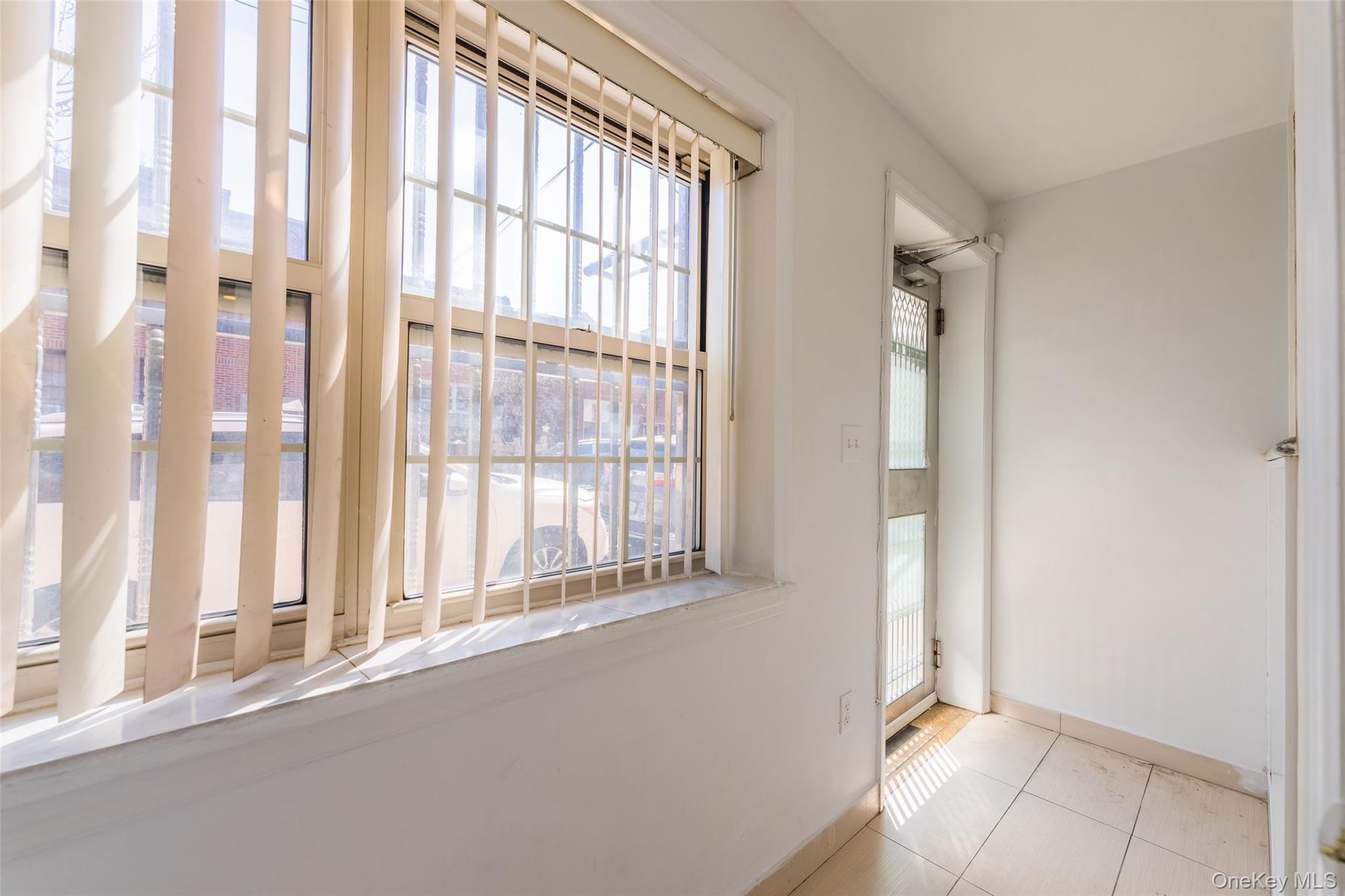 102-23 43rd Avenue, Unit 1B Queens, NY 11368 - Photo 15 of 18 a view of an empty room and window
