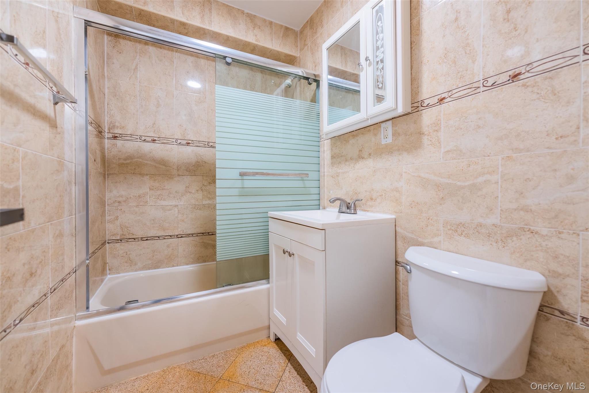 102-23 43rd Avenue, Unit 1B Queens, NY 11368 - Photo 8 of 18 a bathroom with a toilet a sink and a bathtub