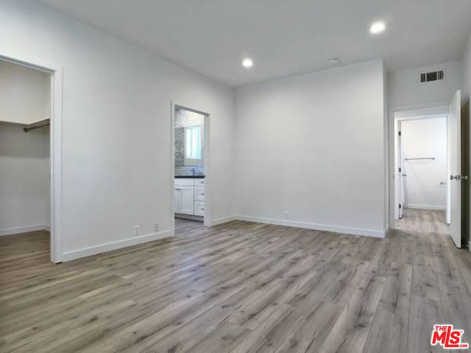 1900 Silver, Unit 104 Los Angeles, CA 90039 - Photo 11 of 21 a view of an empty room with wooden floor and a window