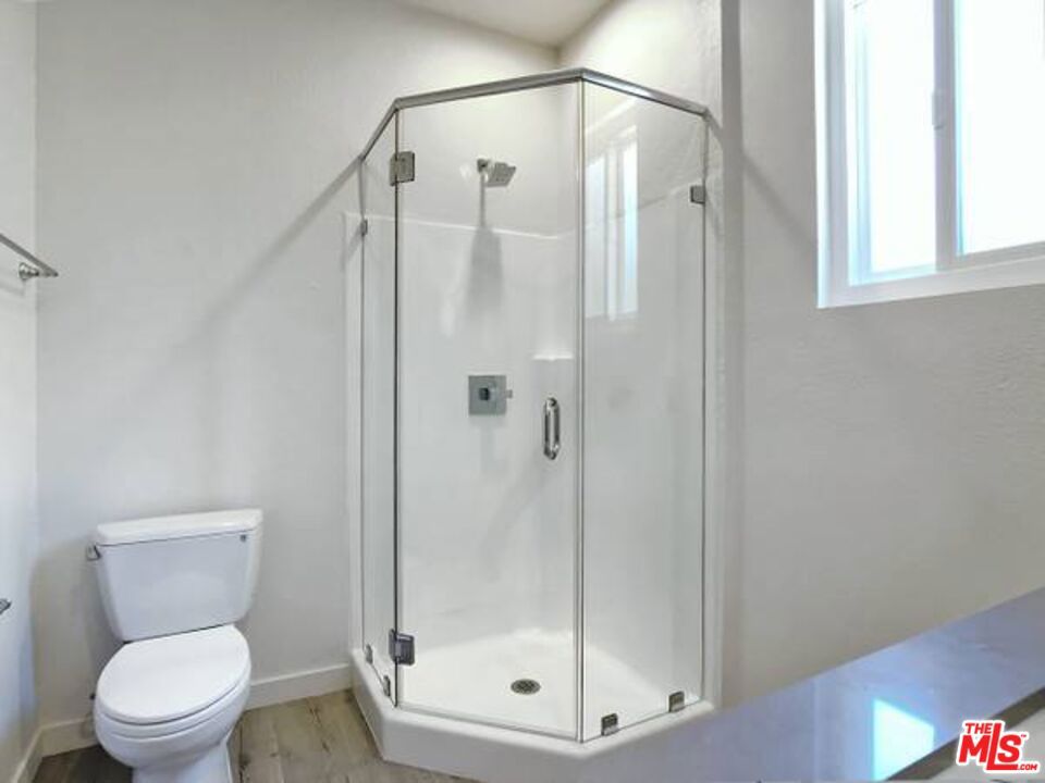 1900 Silver, Unit 104 Los Angeles, CA 90039 - Photo 13 of 21 a bathroom with a shower a toilet and a window
