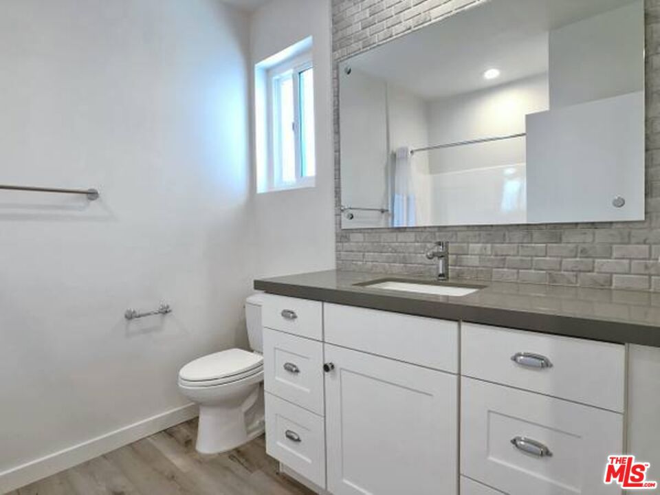 1900 Silver, Unit 104 Los Angeles, CA 90039 - Photo 15 of 21 a bathroom with a toilet sink and mirror