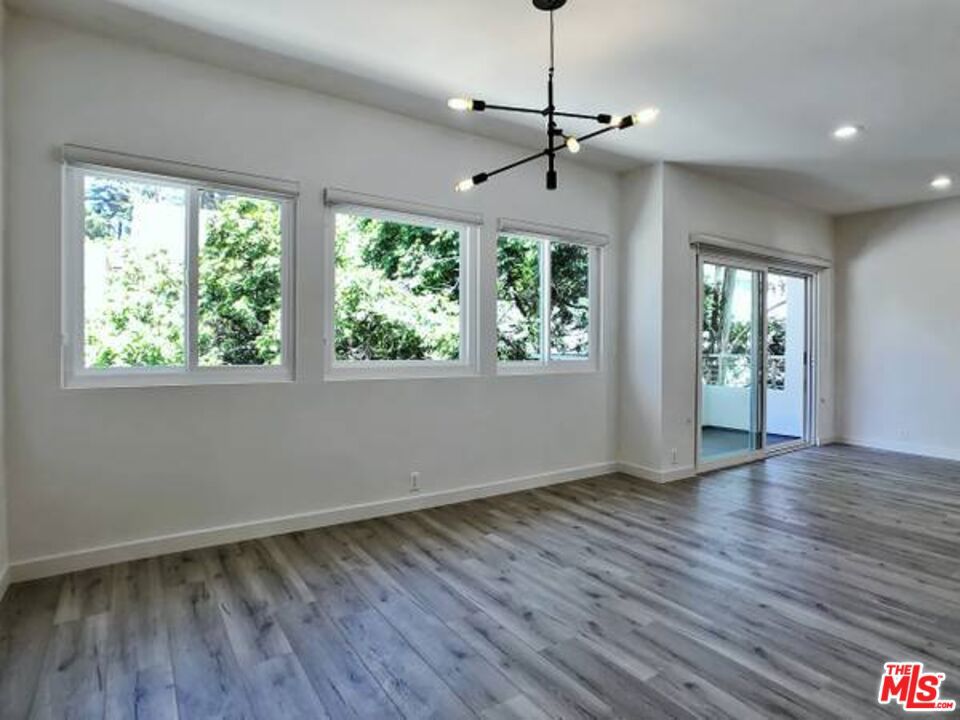 1900 Silver, Unit 104 Los Angeles, CA 90039 - Photo 5 of 21 a view of an empty room with wooden floor and a window