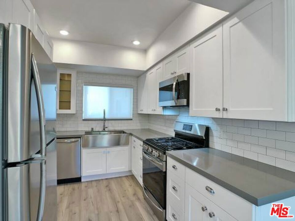1900 Silver, Unit 104 Los Angeles, CA 90039 - Photo 8 of 21 a kitchen with stainless steel appliances granite countertop a sink stove and refrigerator