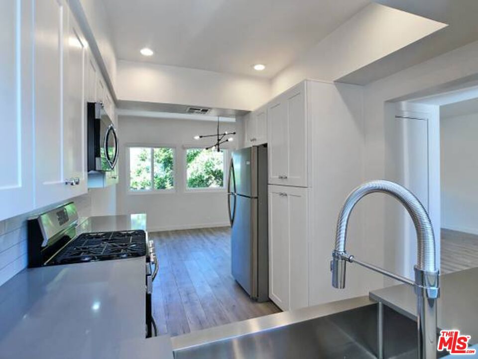 1900 Silver, Unit 104 Los Angeles, CA 90039 - Photo 9 of 21 a kitchen with stainless steel appliances granite countertop a refrigerator and a stove top oven