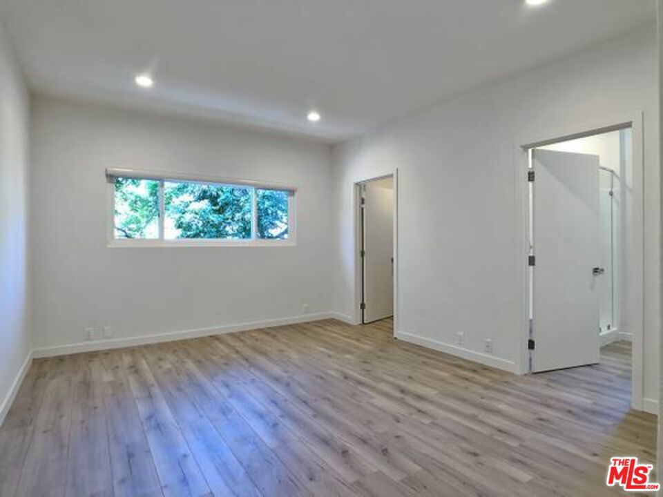 1900 Silver, Unit 104 Los Angeles, CA 90039 - Photo 10 of 21 an empty room with wooden floor cabinet and windows