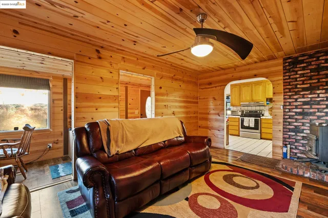 a view of a couch with wooden walls