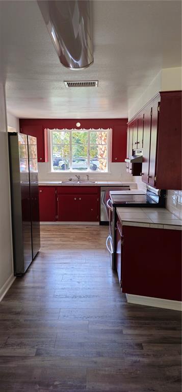 917 East 4th Avenue Mount Dora, FL 32757 - Photo 2 of 9 a kitchen with stainless steel appliances granite countertop a stove a sink and a refrigerator