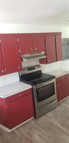 a kitchen with a stove and a microwave