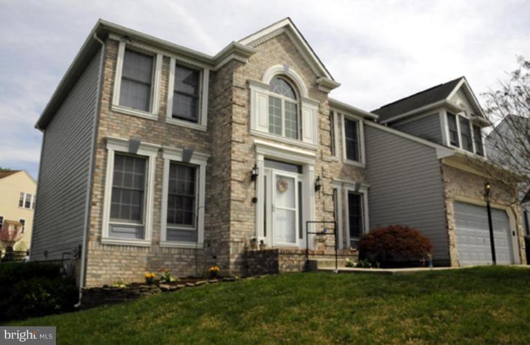819 Sunny Chapel Road Odenton, MD 21113 - Photo 1 of 26 a front view of a house with a garden