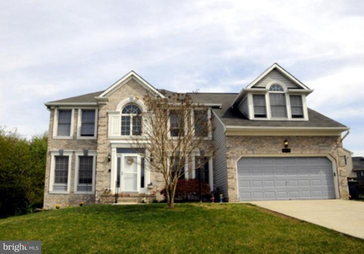 819 Sunny Chapel Road Odenton, MD 21113 - Photo 11 of 26 a front view of a house with a yard and garage