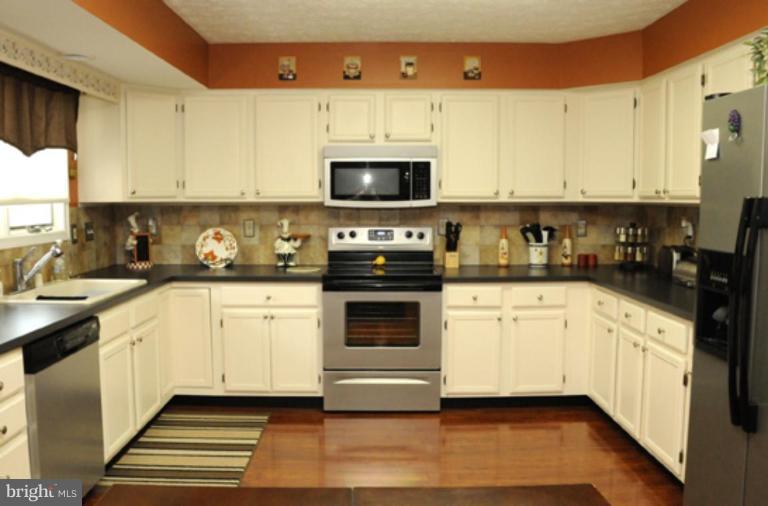 819 Sunny Chapel Road Odenton, MD 21113 - Photo 12 of 26 a kitchen with stainless steel appliances a stove a sink and a microwave