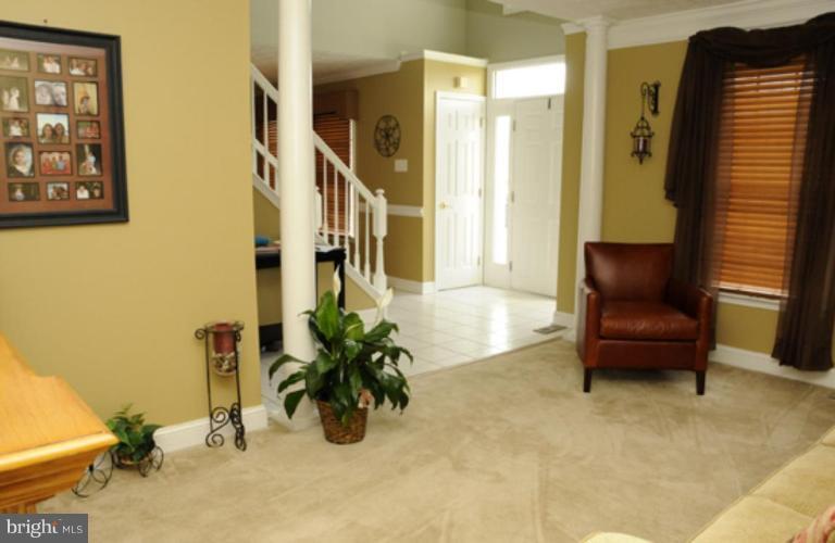 819 Sunny Chapel Road Odenton, MD 21113 - Photo 16 of 26 a living room with furniture and a potted plant