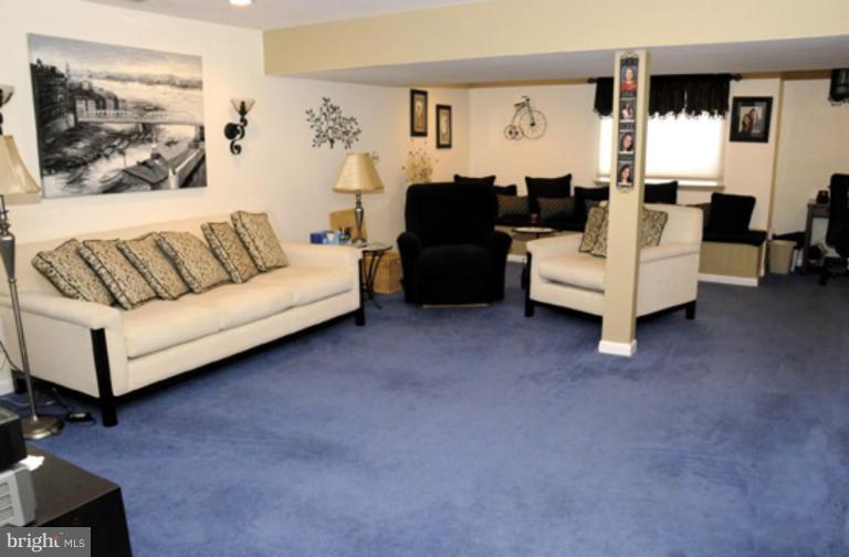 819 Sunny Chapel Road Odenton, MD 21113 - Photo 17 of 26 a living room with furniture and a flat screen tv