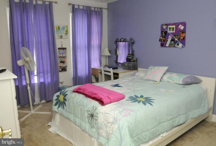 819 Sunny Chapel Road Odenton, MD 21113 - Photo 3 of 26 a bedroom with a bed and a painting on the wall