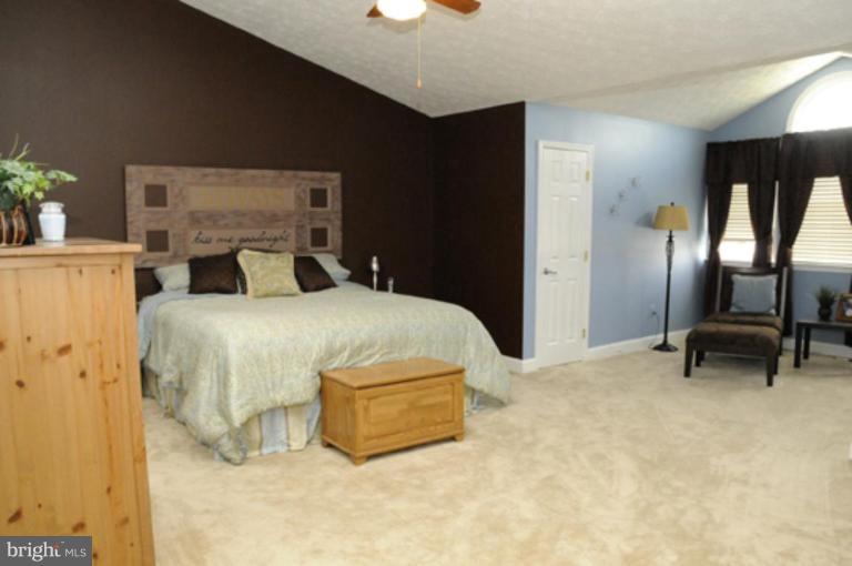 819 Sunny Chapel Road Odenton, MD 21113 - Photo 21 of 26 a bedroom with a bed and a chair