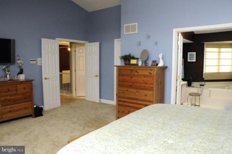819 Sunny Chapel Road Odenton, MD 21113 - Photo 22 of 26 a bedroom with a bed and a flat screen tv
