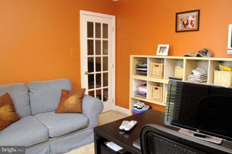 819 Sunny Chapel Road Odenton, MD 21113 - Photo 26 of 26 a living room with furniture a flat screen tv and a window
