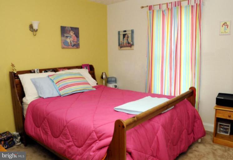 819 Sunny Chapel Road Odenton, MD 21113 - Photo 5 of 26 a bedroom with a bed and a window