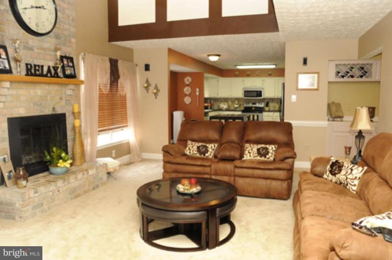 819 Sunny Chapel Road Odenton, MD 21113 - Photo 9 of 26 a living room with furniture a fireplace and a large mirror