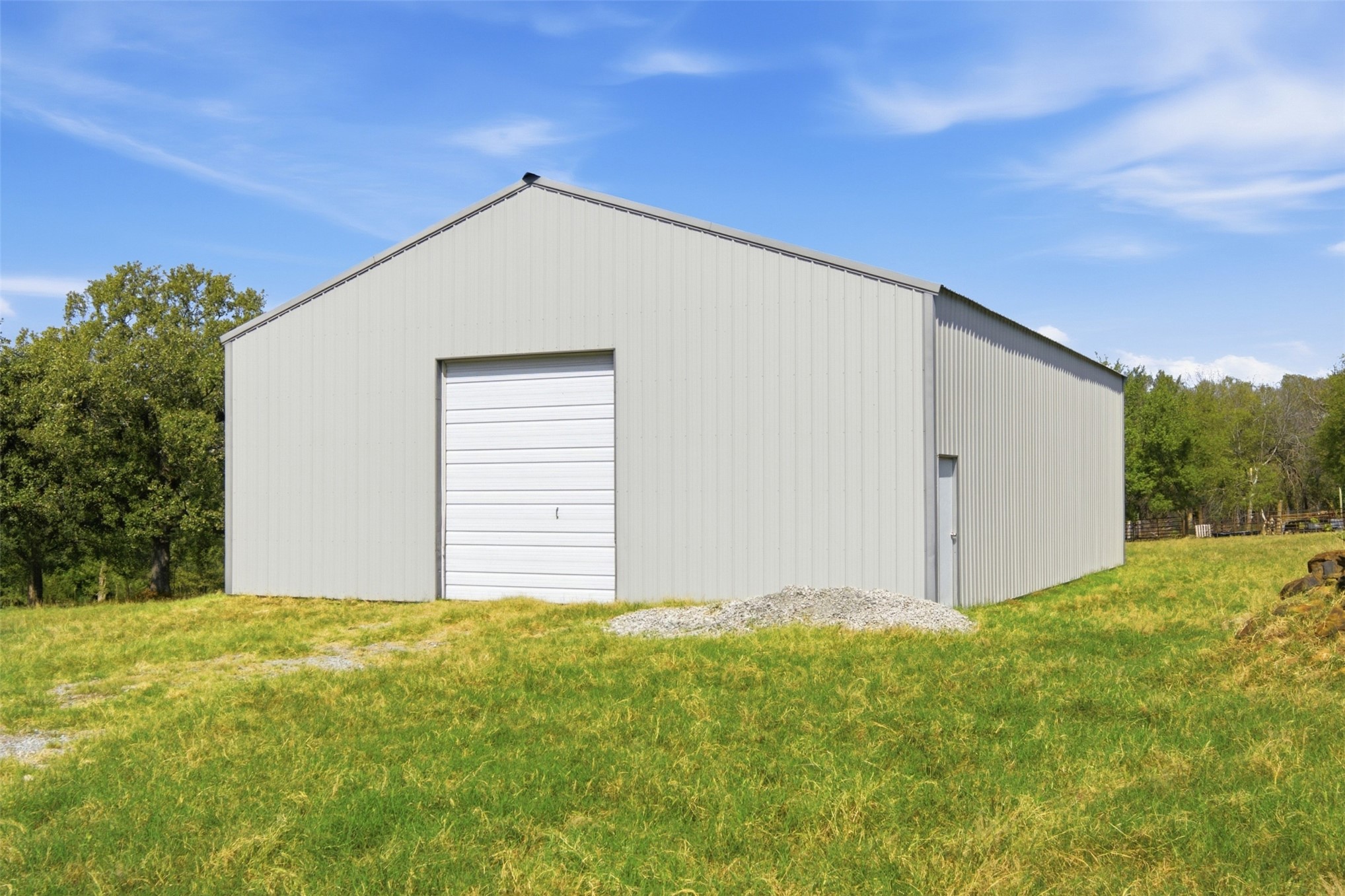 17875 East 589 Road Inola, OK 74036 - Photo 2 of 73 Metal shop 40x50 gable roof, large roll-up garage door, and a single side entry door
