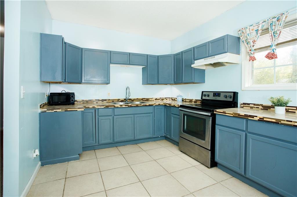 3831 Fairmont Avenue Macon, GA 31204 - Photo 12 of 29 a kitchen with a sink a stove and cabinets