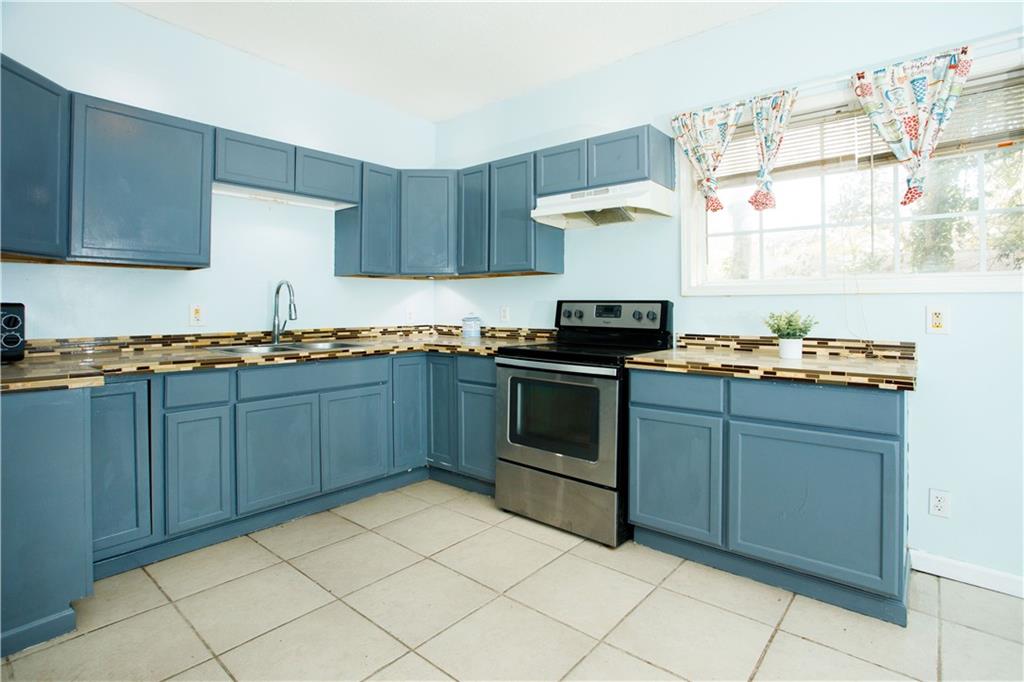 3831 Fairmont Avenue Macon, GA 31204 - Photo 13 of 29 a kitchen with stainless steel appliances granite countertop a stove a sink and a refrigerator