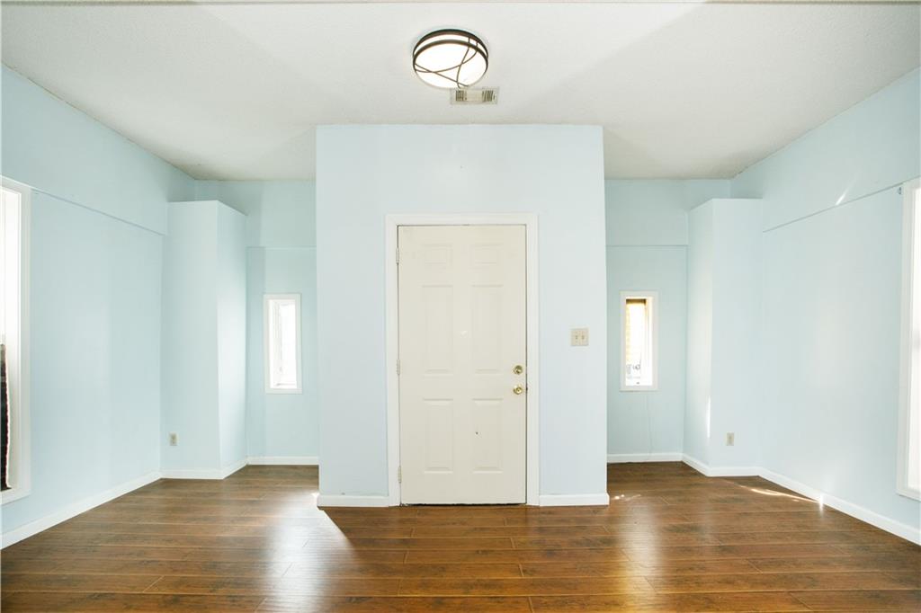 3831 Fairmont Avenue Macon, GA 31204 - Photo 6 of 29 an empty room with wooden floor mirror and window
