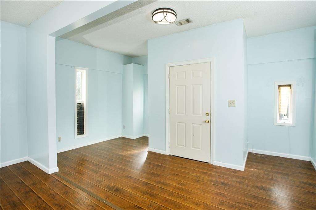 3831 Fairmont Avenue Macon, GA 31204 - Photo 7 of 29 an empty room with wooden floor and windows