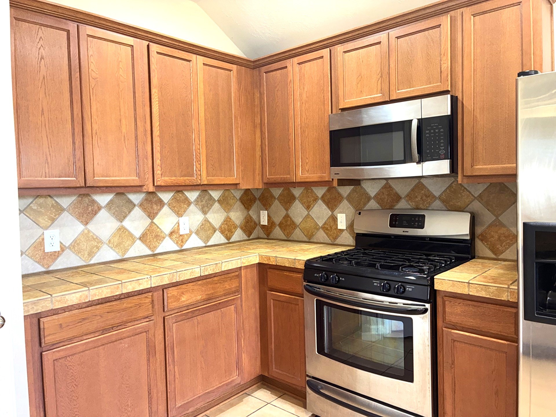 3418 Cypress Landing Court Rosenberg, TX 77471 - Photo 12 of 23 a kitchen with stainless steel appliances granite countertop white cabinets and a stove