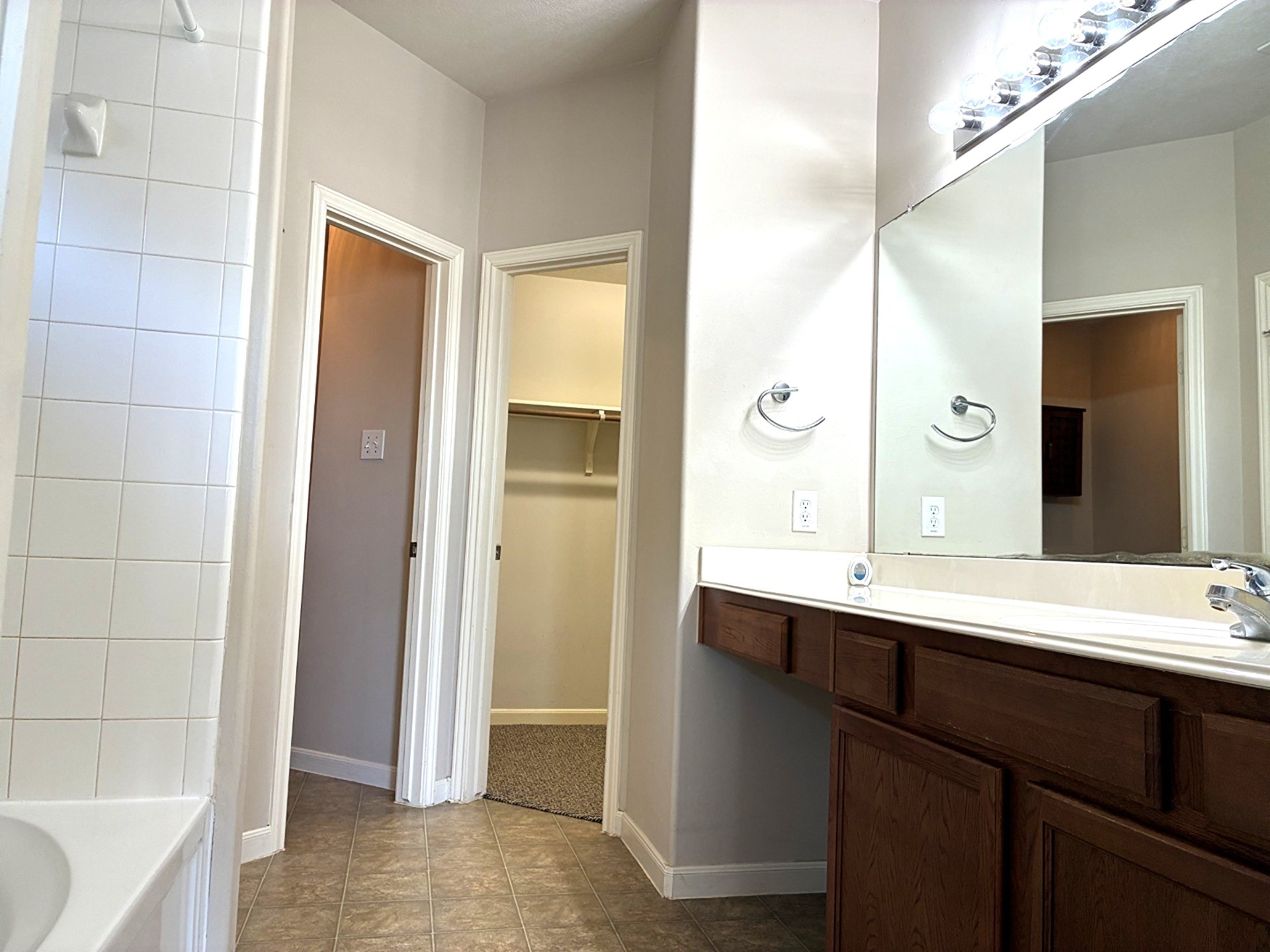 3418 Cypress Landing Court Rosenberg, TX 77471 - Photo 17 of 23 a bathroom with a double vanity sink a mirror and a bathtub