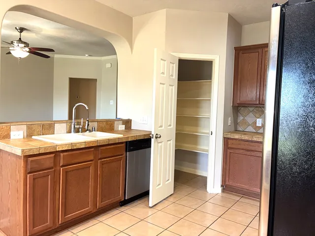 a kitchen with stainless steel appliances granite countertop a refrigerator and a sink