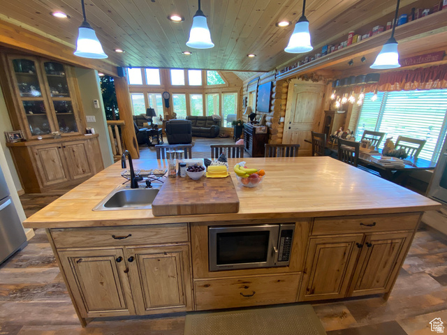 79 Auburn Forest Road Auburn, WY 83111 - Photo 76 of 76 Kitchen with wooden counters, decorative light fixtures, open floor plan, stainless steel appliances, and wooden ceiling