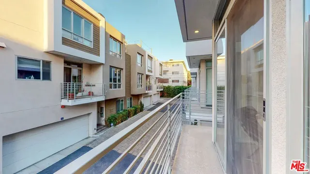 a living room with furniture a flat screen tv and a large window