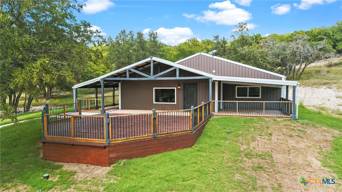 a view of a house with a yard and sitting area