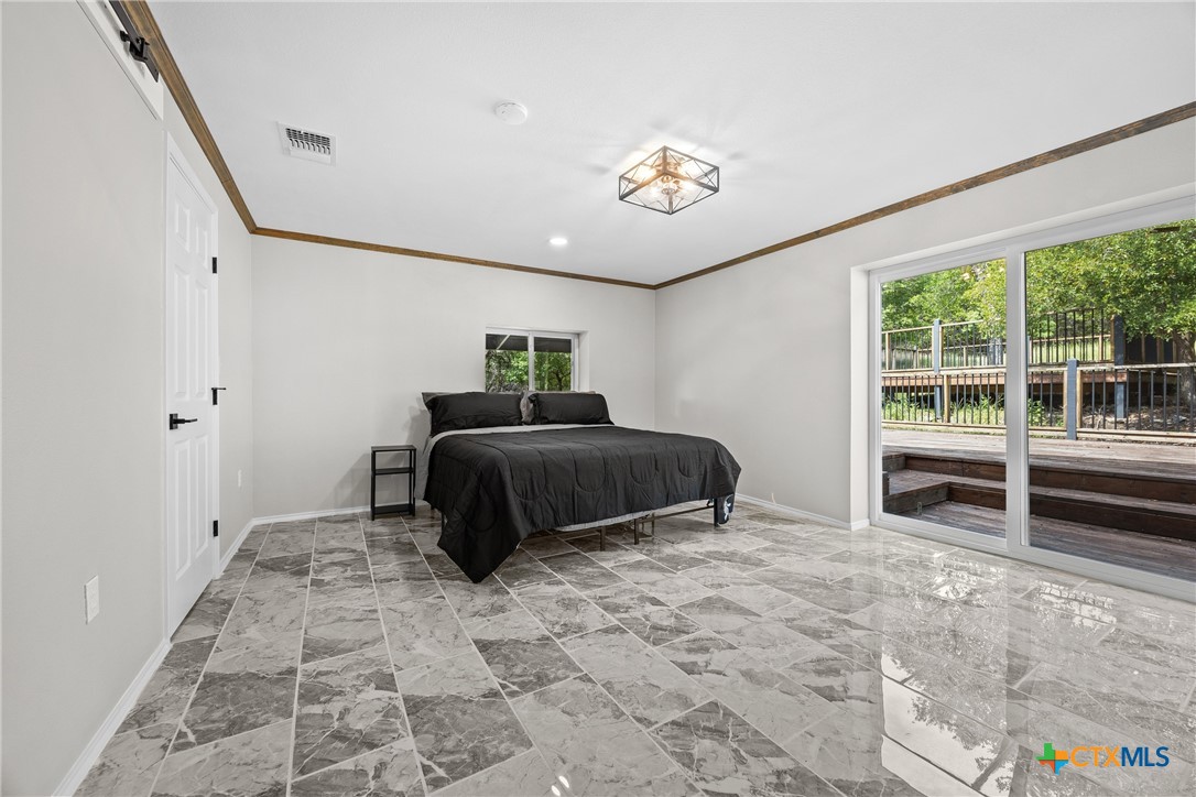 115 Spotted Fawn Gatesville, TX 76528 - Photo 22 of 38 a bedroom with a bed and a large window