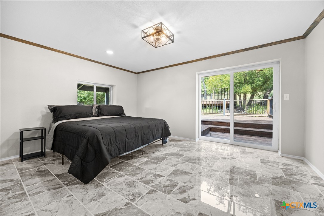 115 Spotted Fawn Gatesville, TX 76528 - Photo 25 of 38 a bedroom with a bed and a large window