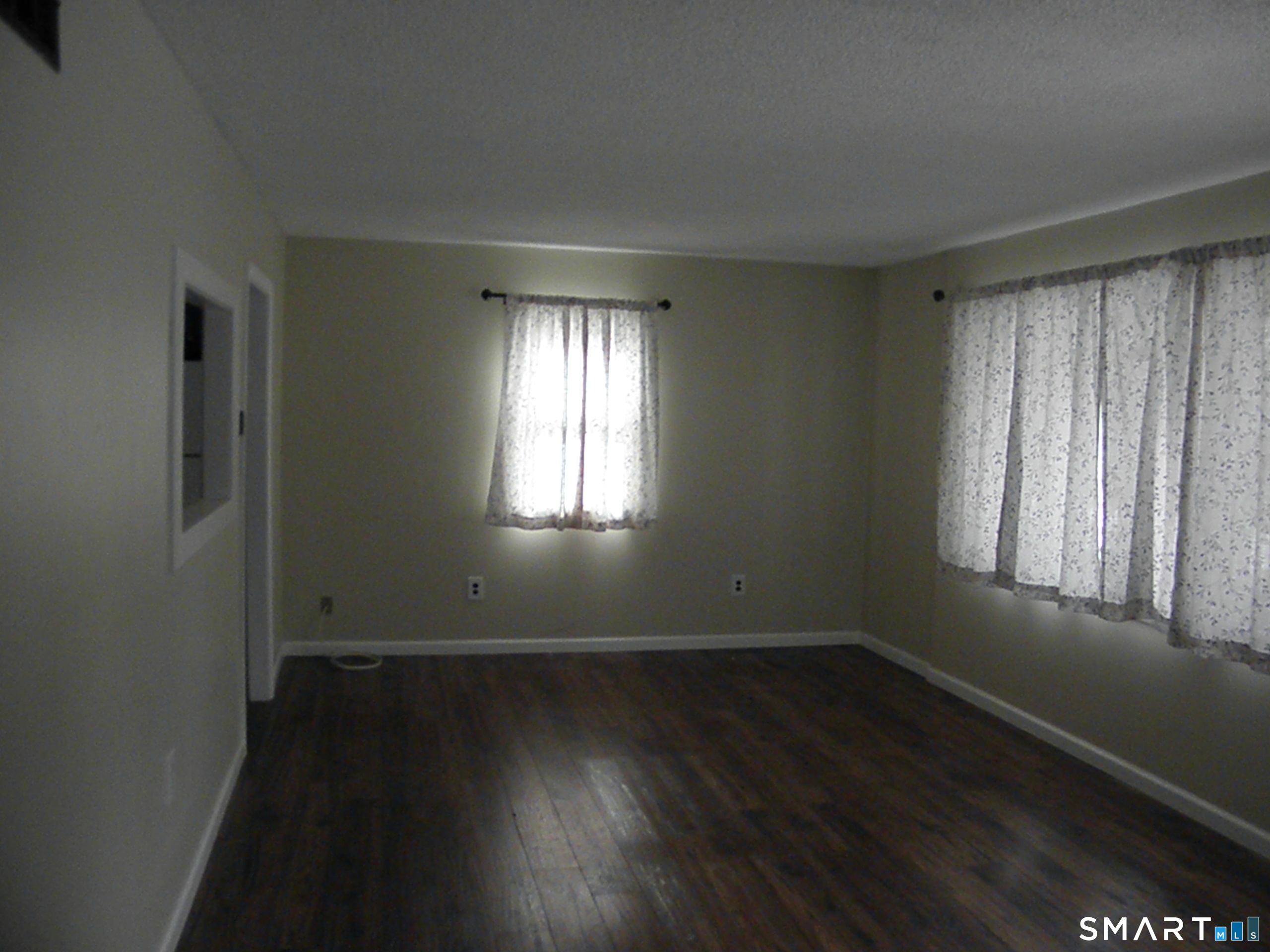 32 Walnut Circle Windsor Locks, CT 06096 - Photo 6 of 11 an empty room with wooden floor and windows