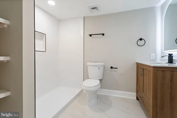 a bathroom with a toilet a sink and shower