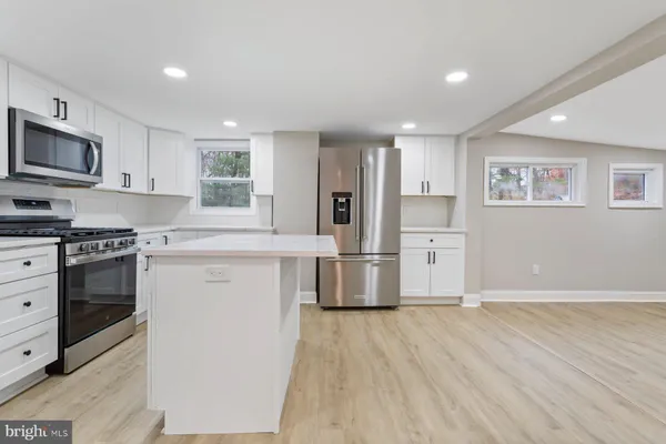 a kitchen with stainless steel appliances a refrigerator stove and microwave