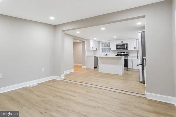 a view of kitchen with stainless steel appliances cabinets