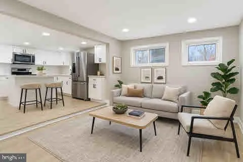 a living room with furniture and kitchen view
