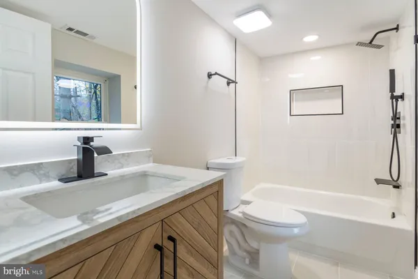 a bathroom with a sink a toilet and a bathtub