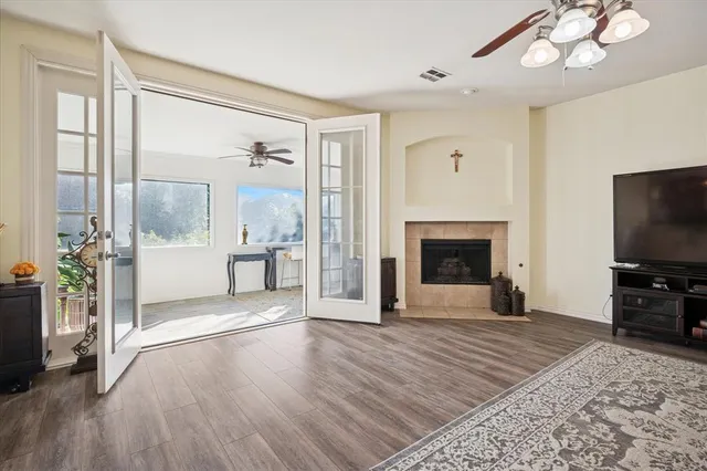a view of a livingroom with wooden floor and a fireplace