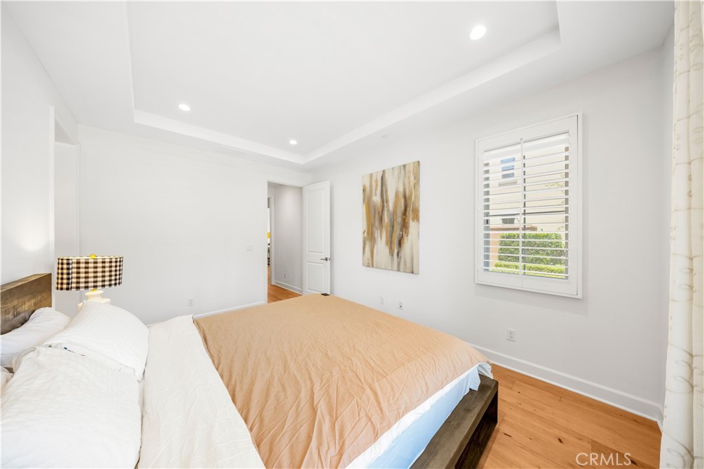 61 Belfast Irvine, CA 92620 - Photo 18 of 24 a bedroom with a bed and wooden floor