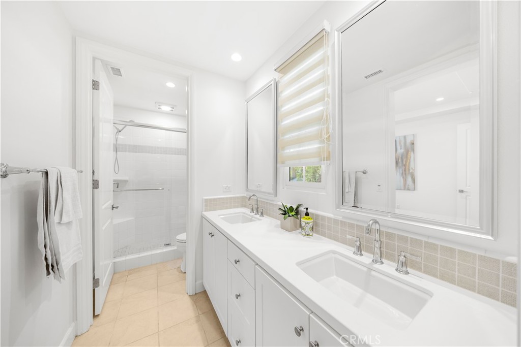 61 Belfast Irvine, CA 92620 - Photo 19 of 24 a bathroom with a double vanity sink mirror double and shower