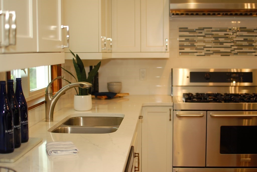 611 Hayward Mill Road Concord, MA 01742 - Photo 3 of 19 a kitchen with stainless steel appliances granite countertop a sink stove and refrigerator