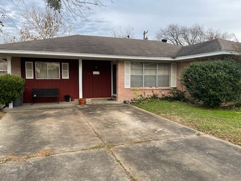 1610 Bexar Avenue Victoria, TX 77901 - Photo 1 of 30 a front view of a house with a yard and garage