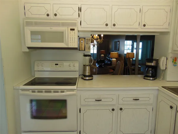 a kitchen with appliances cabinets and a counter top space